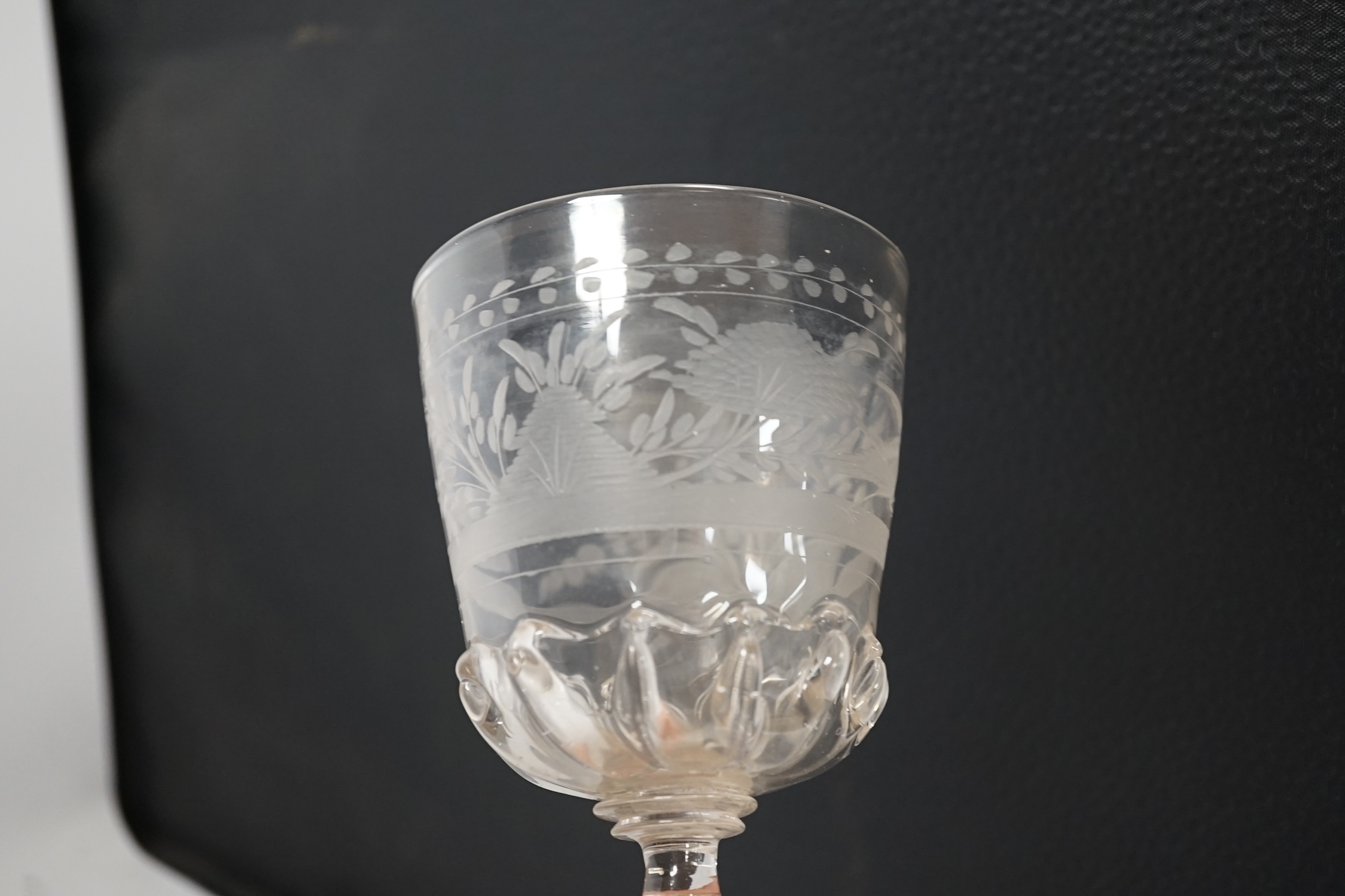 A Dutch or Bohemian glass goblet with engraved bowl, in late 17th century style, 23cm high. Condition - good